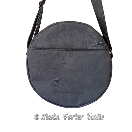 back view of handmade, hand painted bag with very dark grey colouring and featuring two handpainted spiders and spider webs