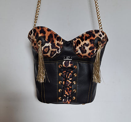 Sculptural bag in the shape of a female torso designed like a black basque with leopard detail and gold tassels