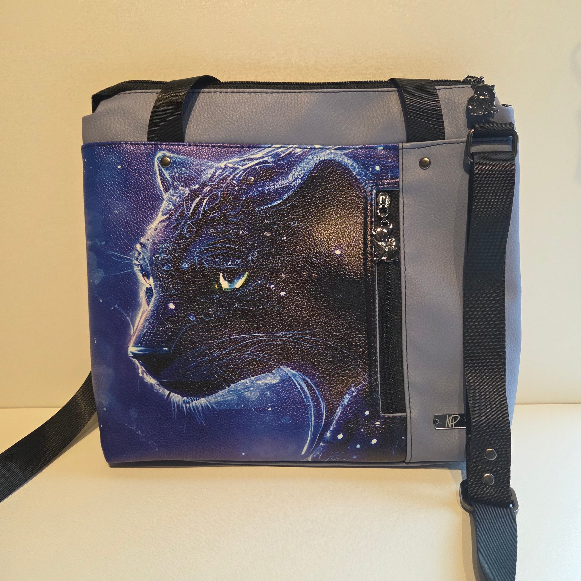 Pale blue bag featuring a ethereal panther on a starry background