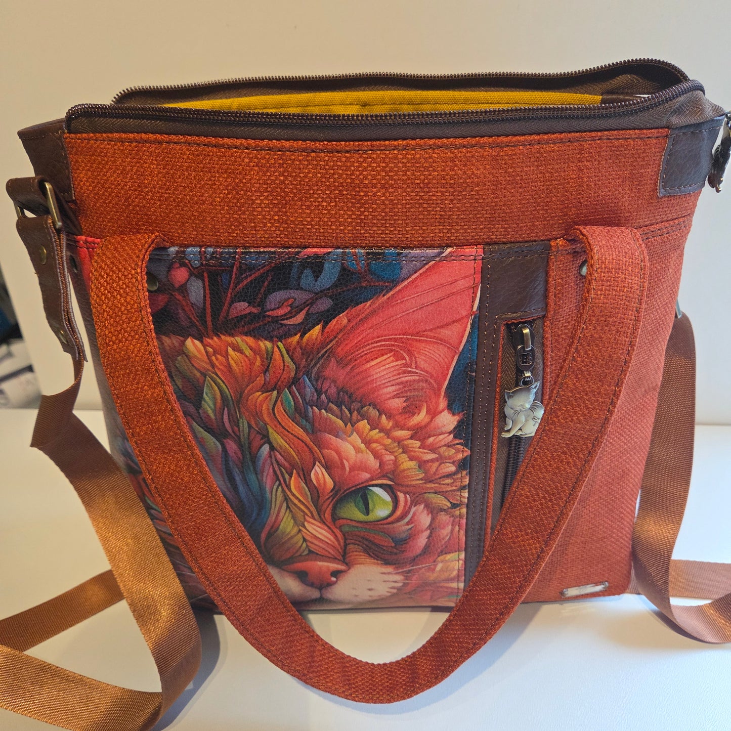 Orange fabric tote bag with printed cat , brown accents and brass hardware