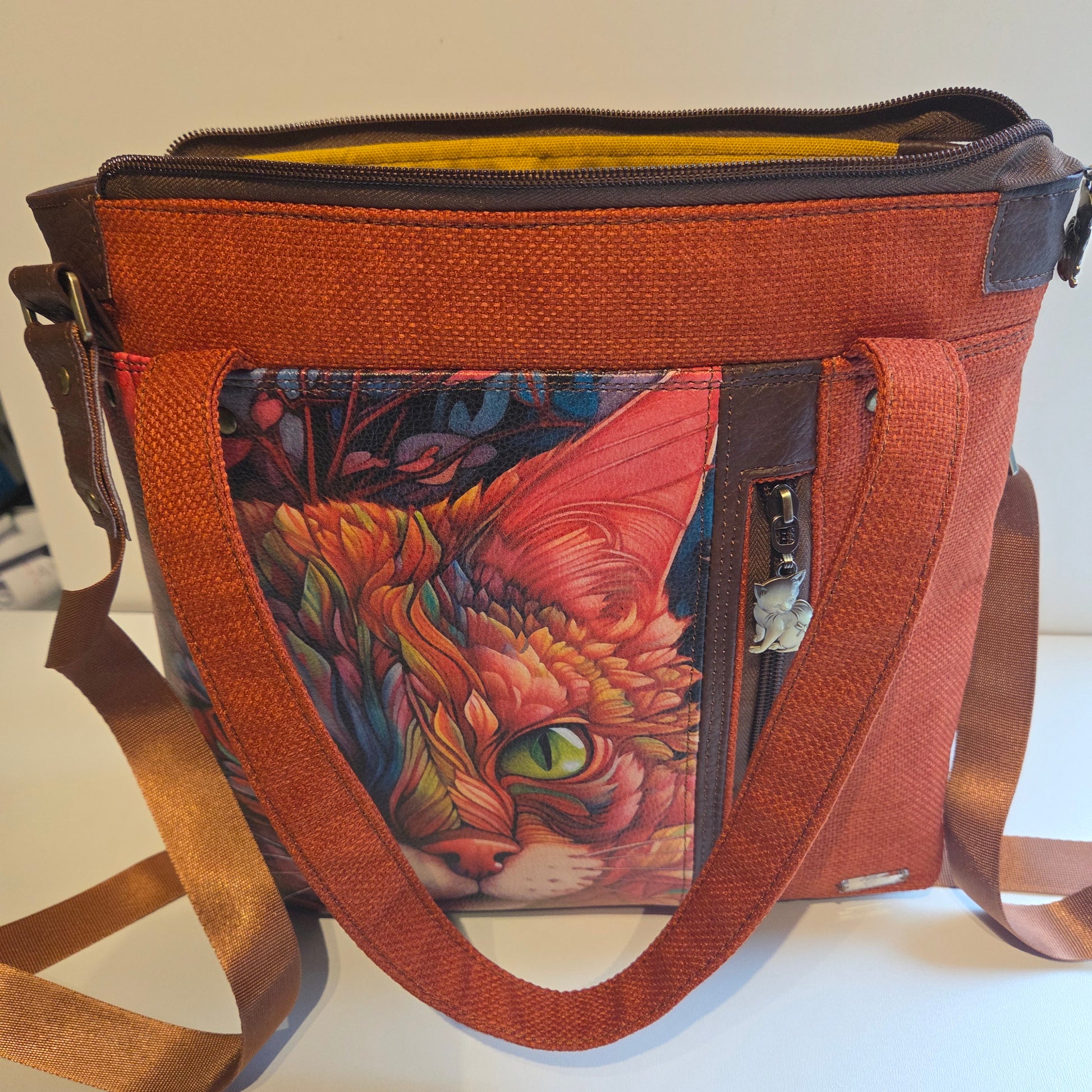 Orange fabric tote bag with printed cat , brown accents and brass hardware