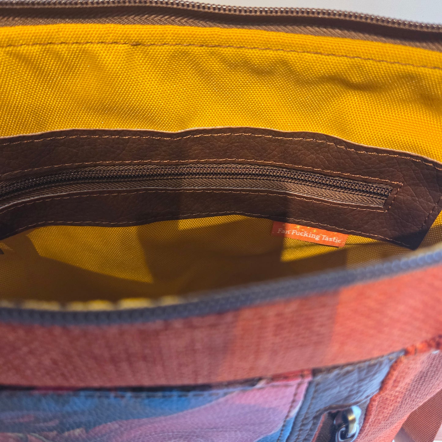 inside of bag with brown accented zipper pocket and swear label