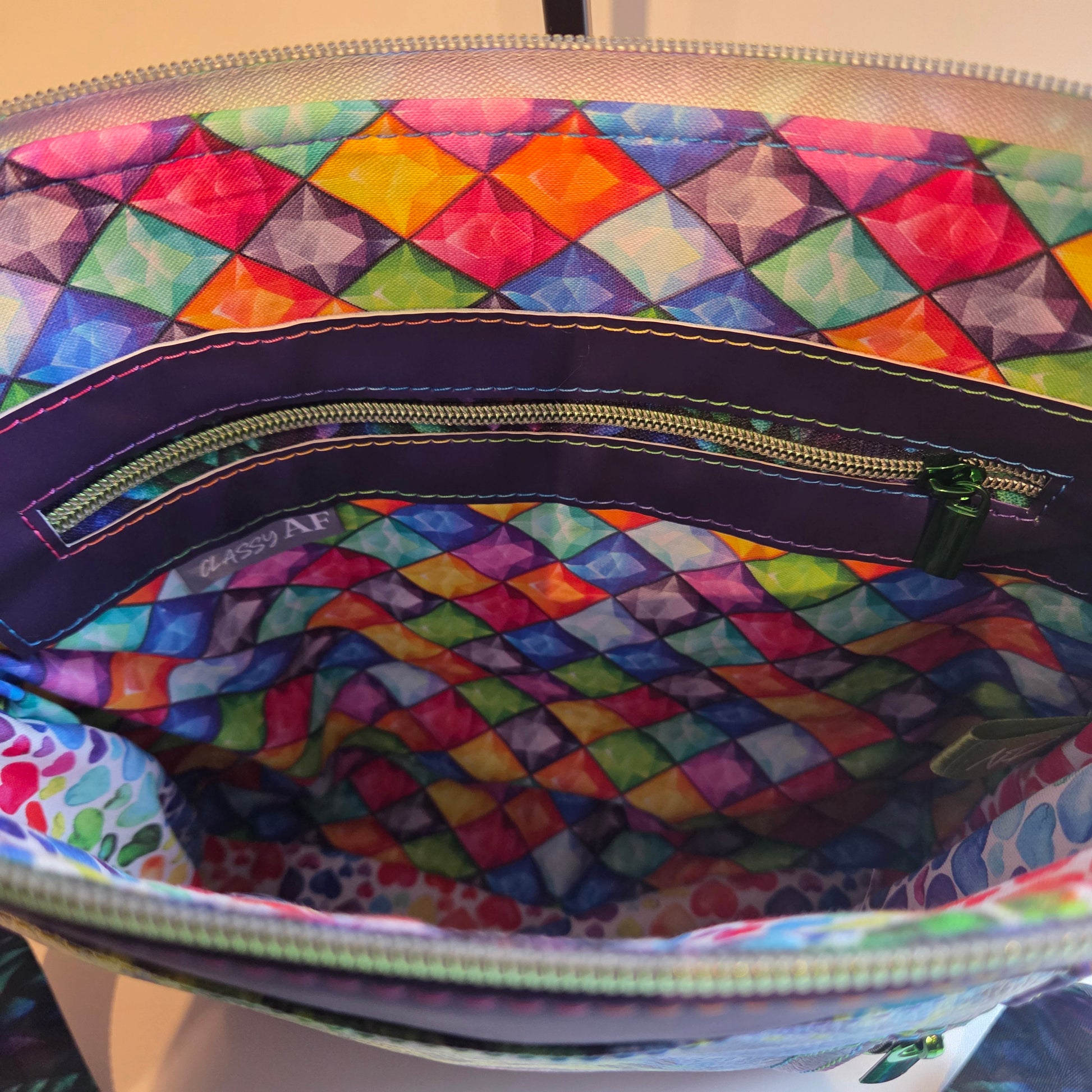 Colourful geometric patterned bag lining with zipper pocket and classy AF label