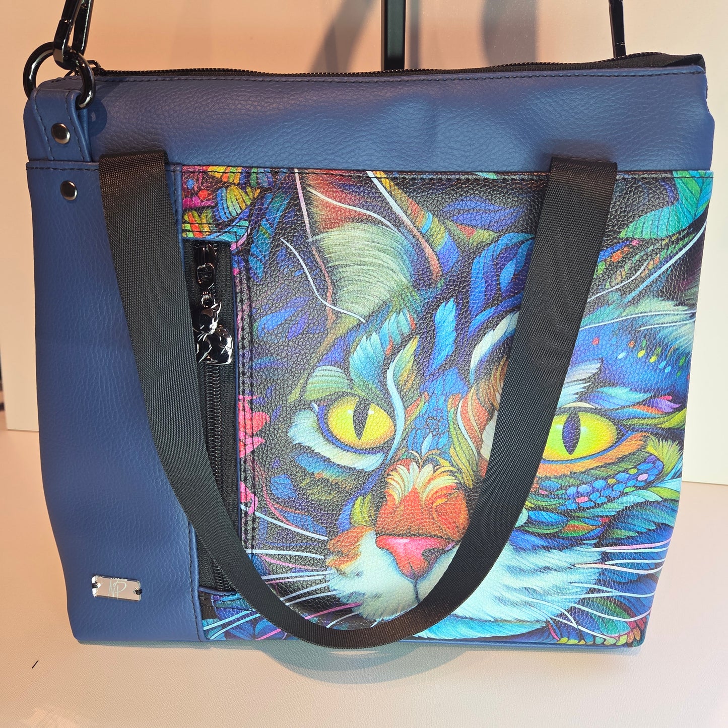 Blue tote bag with a colourful cat design